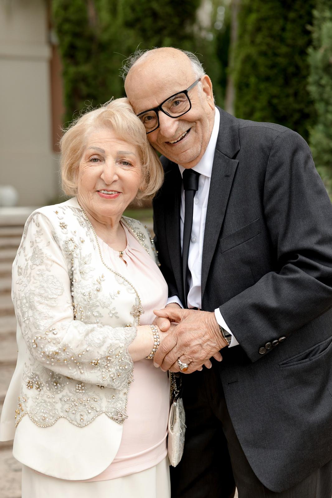 The founder's parents in their nineties, sitting in a garden