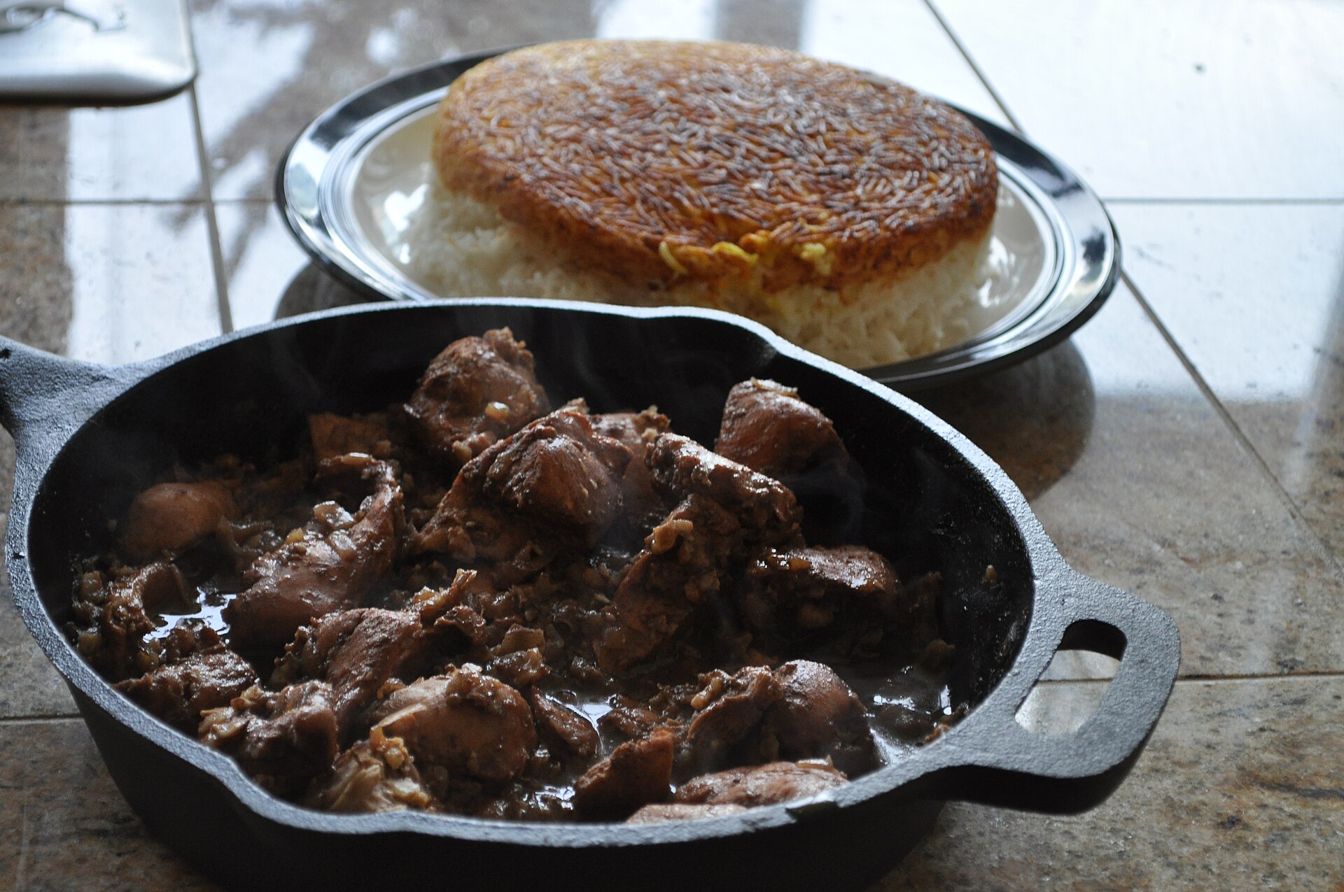 Fesenjan — a dark Persian walnut and pomegranate stew, served with rice and tahdig.