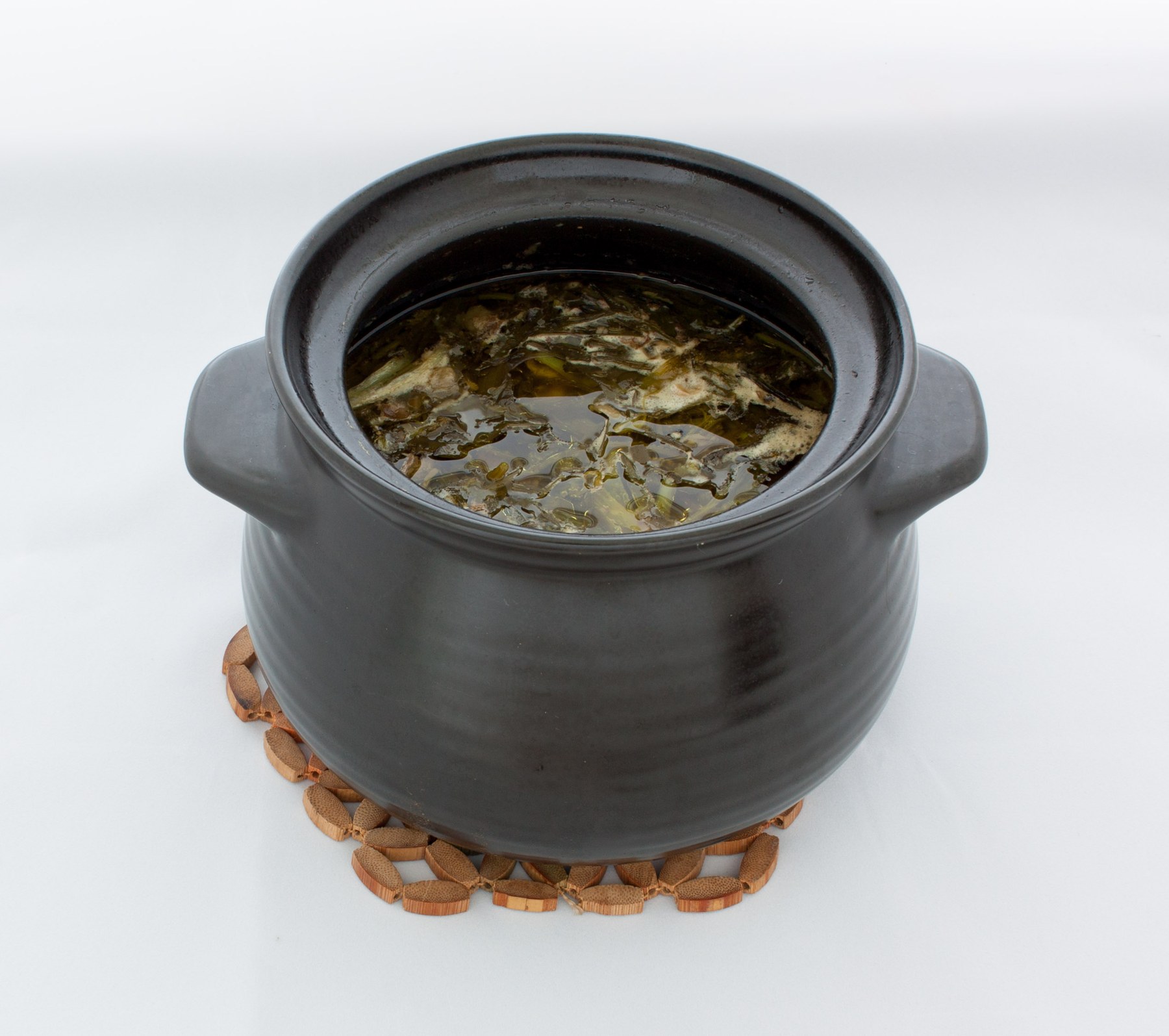 Abgoosht served in a stone dizi pot with bread.