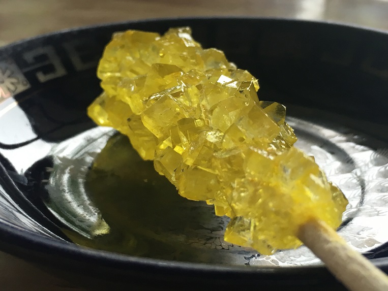 Golden saffron nabat sticks, whole crystal sugar sticks laid side by side